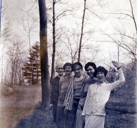 women smiling with one waving hello